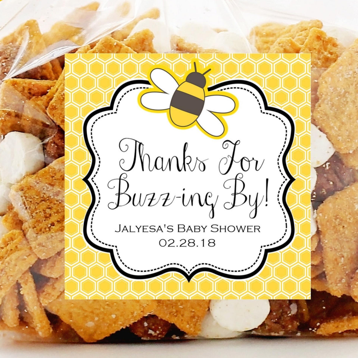 Bumble bee baby shower sticker with honeycomb pattern background