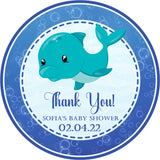 Blue whale baby shower sticker with underwater bubbles and wave background