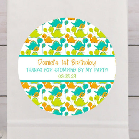 Cute dinosaur birthday sticker with teal and orange baby dinosaurs