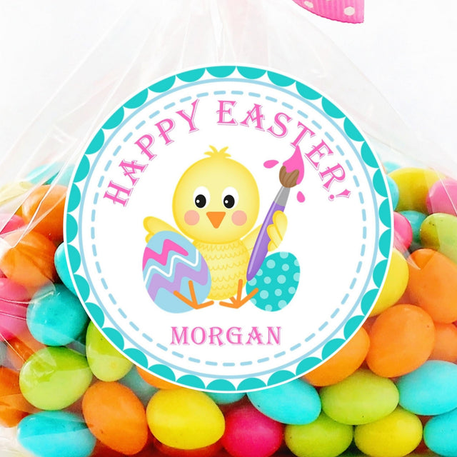 Easter sticker featuring a yellow chick painting a colorful Easter egg with pastel accents