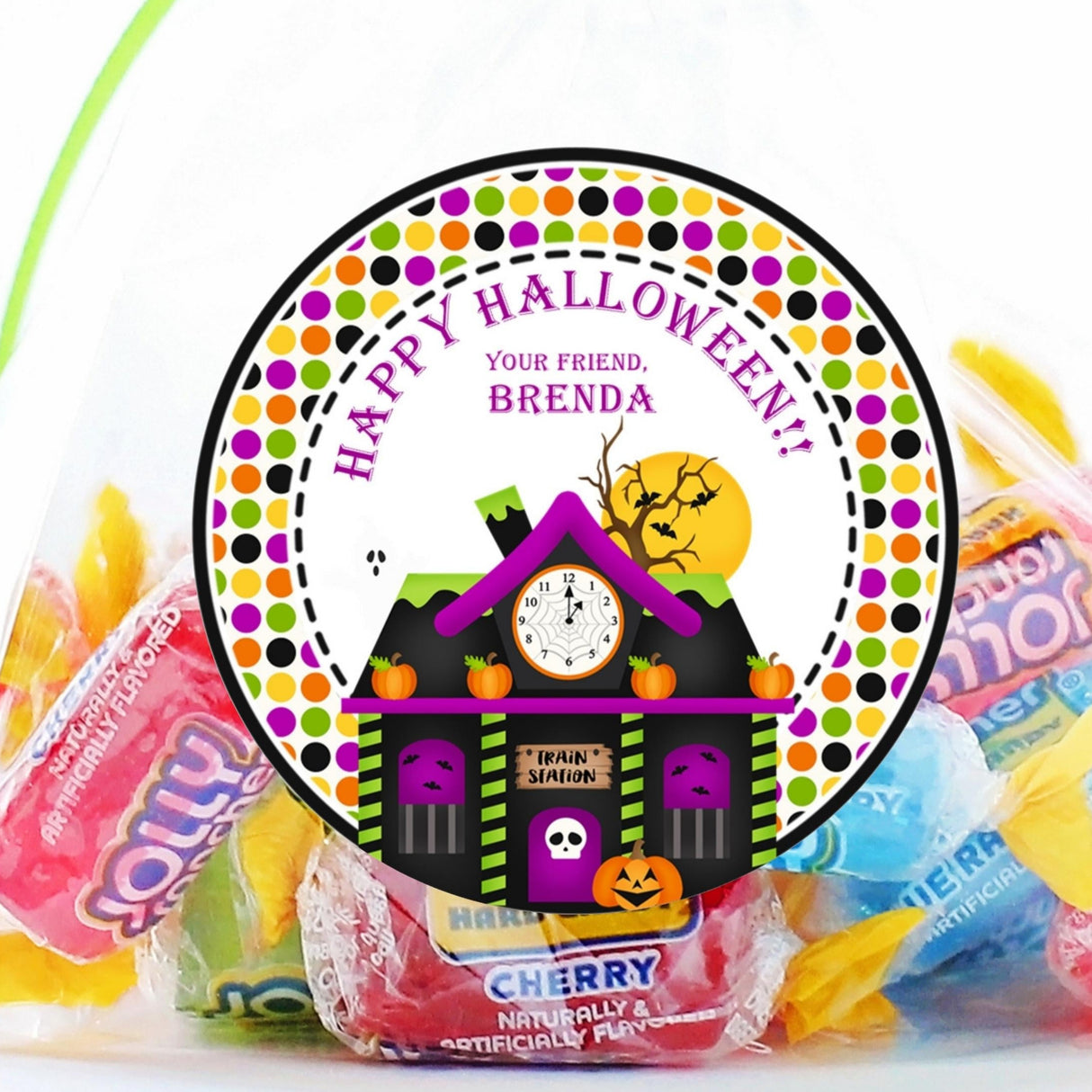 Haunted train station Halloween sticker with pumpkins, bats, and clock tower