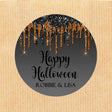 round halloween sticker with black background and cascading orange drip accents
